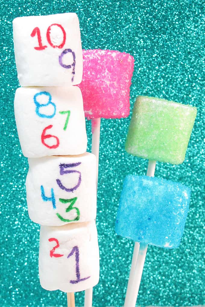 Easy fun food idea for New Year's Eve: NEW YEAR'S EVE MARSHMALLOWS. Food coloring pens, sprinkles, and marshmallows are all you need. Fun party idea for kids. 