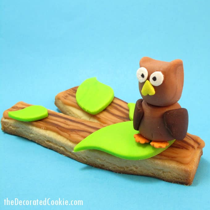 Fall cookie idea: Tree branch cookies with a painted wood grain and a fondant owl. #Fondant #Owls #TreeBranchCookies #CookiePainting #FallCookies