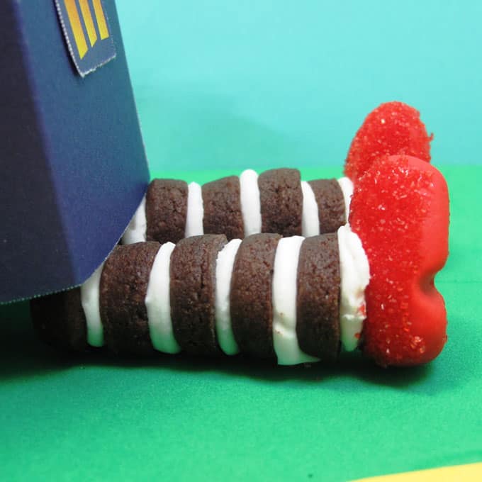Wizard of Oz cookies: Mini chocolate cookies with fondant ruby slippers to look like the witch's legs from the Wizard of Oz #WizardOfOz #Cookies #WickedWitch #Halloween 