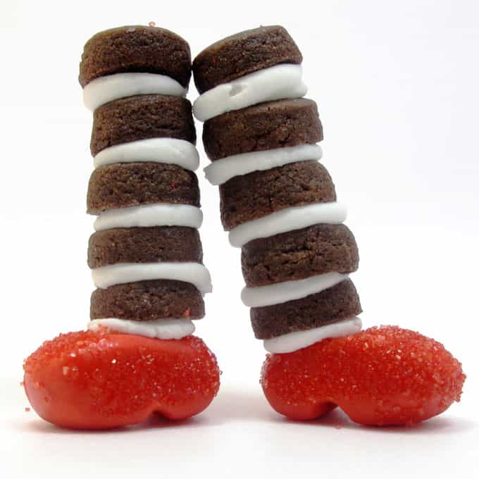 Wizard of Oz cookies: Mini chocolate cookies with fondant ruby slippers to look like the witch's legs from the Wizard of Oz #WizardOfOz #Cookies #WickedWitch #Halloween