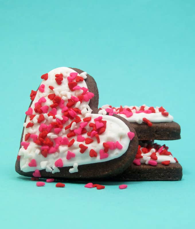 Heart sprinkle marshmallows and cookies with royal icing for easy Valentine's Day treats. 