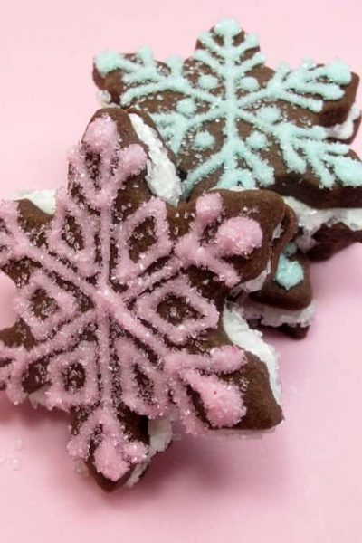 Chocolate snowflake sandwich cookies are a sparkly, beautiful decorated cookie to make this holiday season for Christmas or winter.