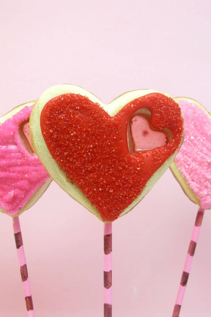 stained glass heart cookie pops for Valentine's Day -- the decorated cookie #ValentinesDay #cookies #heartcookies #stainedglasscookies 