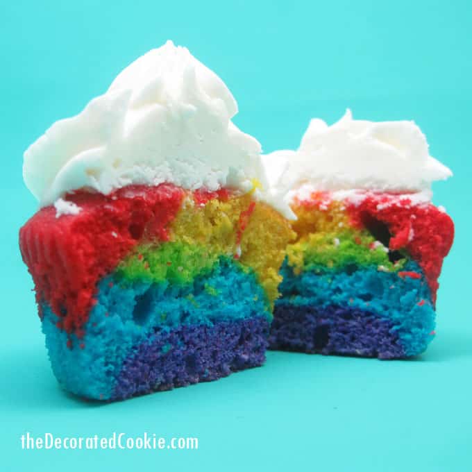 Rainbow cake and cupcakes with buttercream frosting for a unicorn or rainbow party -- the decorated cookie 