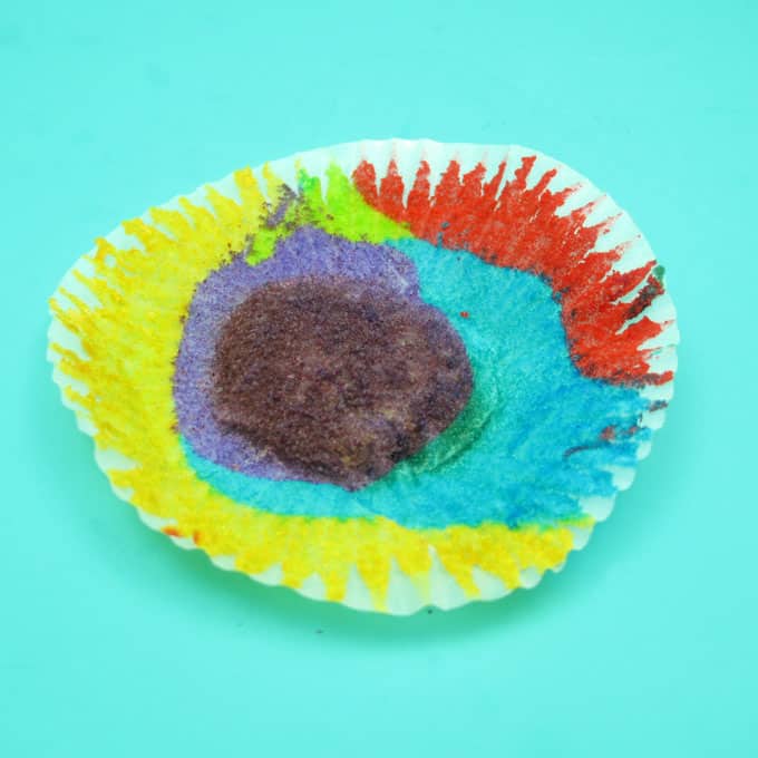 Rainbow cake and cupcakes with buttercream frosting for a unicorn or rainbow party -- the decorated cookie 