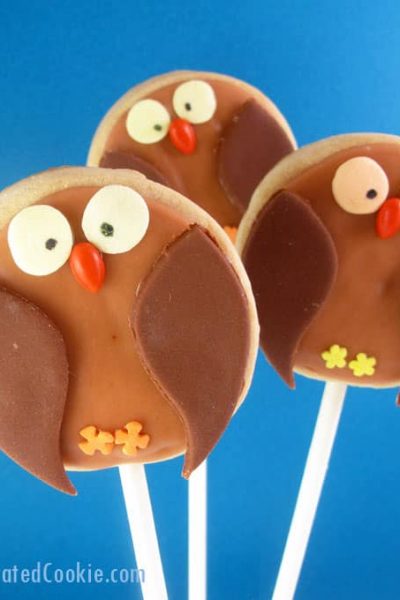 owl cookies on a stick with fondant and royal icing, a fun food treat for fall or Halloween -- the decorated cookie