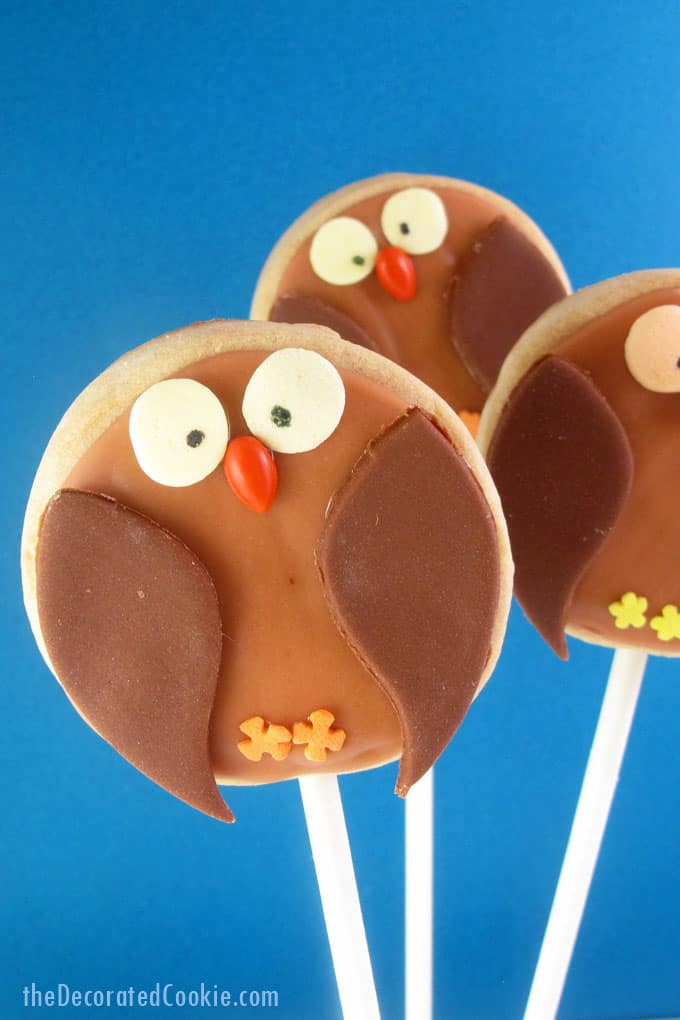 owl cookies on a stick with fondant and royal icing, a fun food treat for fall or Halloween -- the decorated cookie