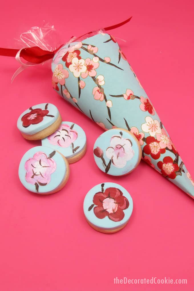 painted cherry blossom cookies in paper cones 