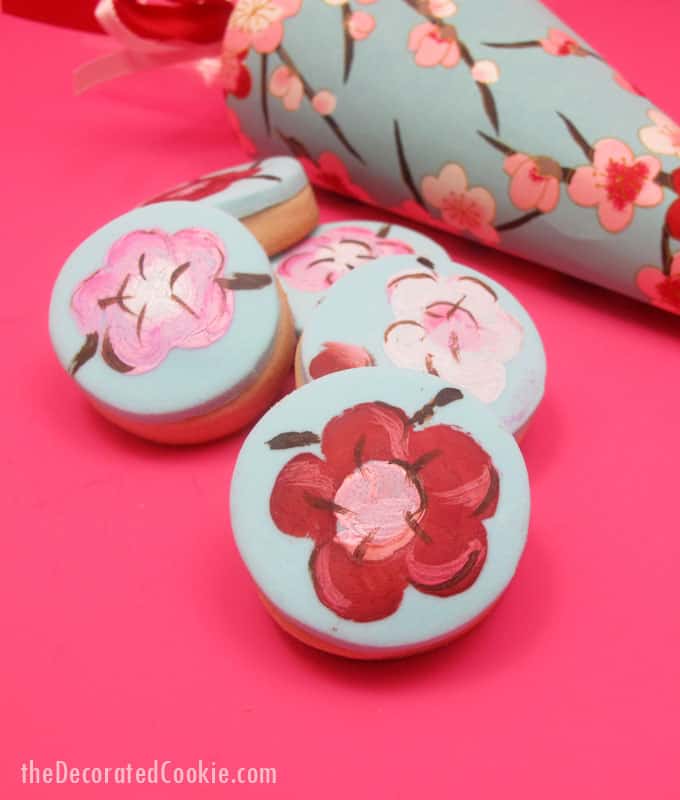 painted cherry blossom cookies in paper cones 