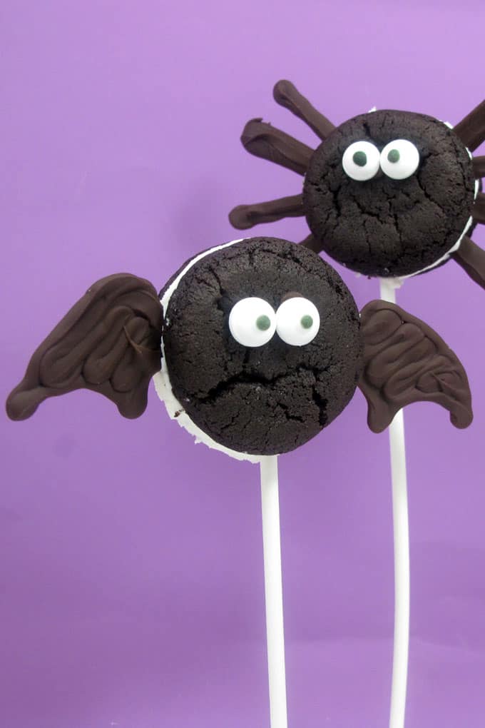 Oreo Cakester bat and spider pops for Halloween. Store-bought cookies, chocolate, and sticks for an easy Halloween party food idea.