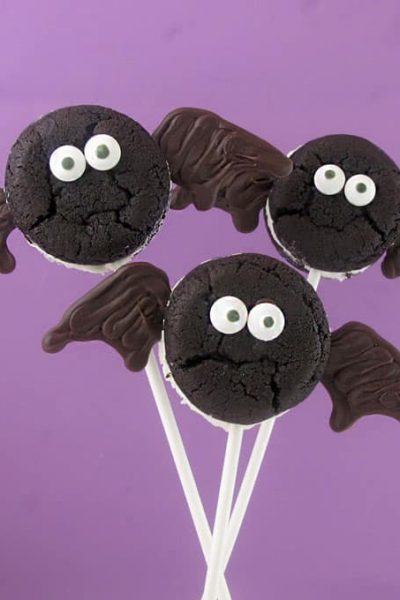Oreo Cakester bat and spider pops for Halloween. Store-bought cookies, chocolate, and sticks for an easy Halloween party food idea.