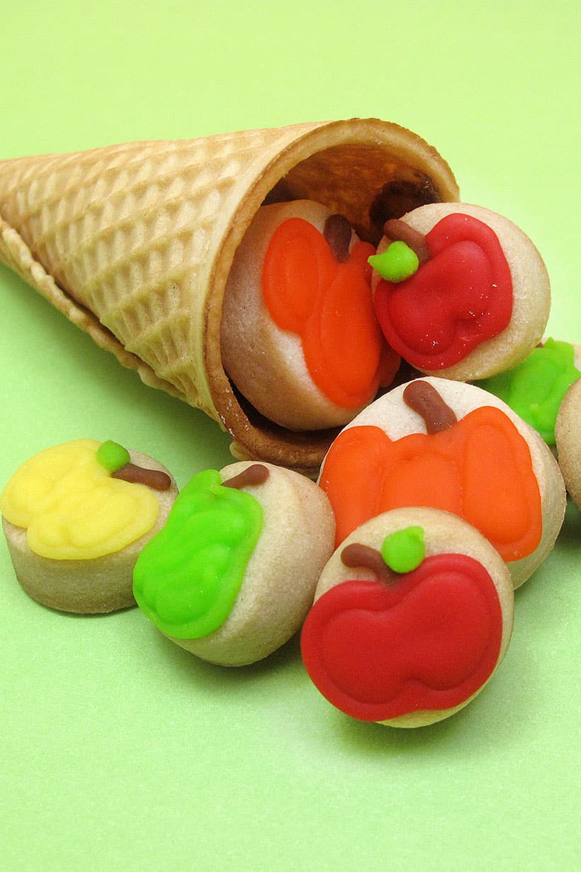 mini decorated fruit and pumpkin cookies in ice cream cone