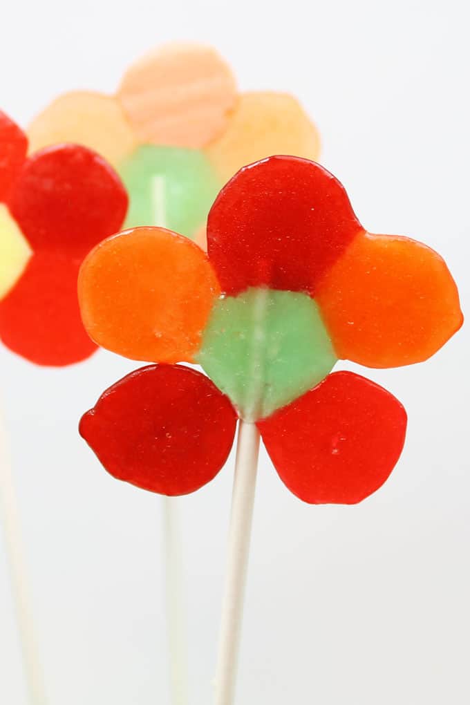 How to make easy Life Savers® Candy lollipops flowers, a kid-friendly fun food idea for spring. Melt store-bought candy and add sticks.