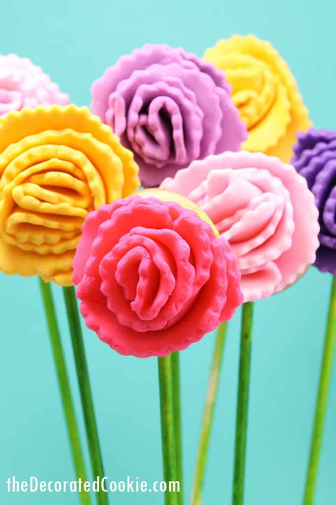 How to decorate carnation flower cookies on a stick using fondant and royal icing, and sugar cookies, a fun food idea for spring. 