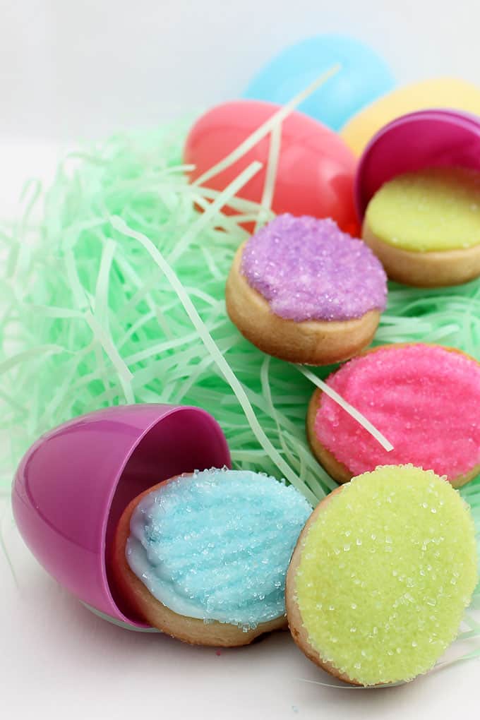 How to decorate mini Easter egg cookies. Quick and easy Easter cookie treat with cut-out sugar cookies, royal icing, and sprinkles.