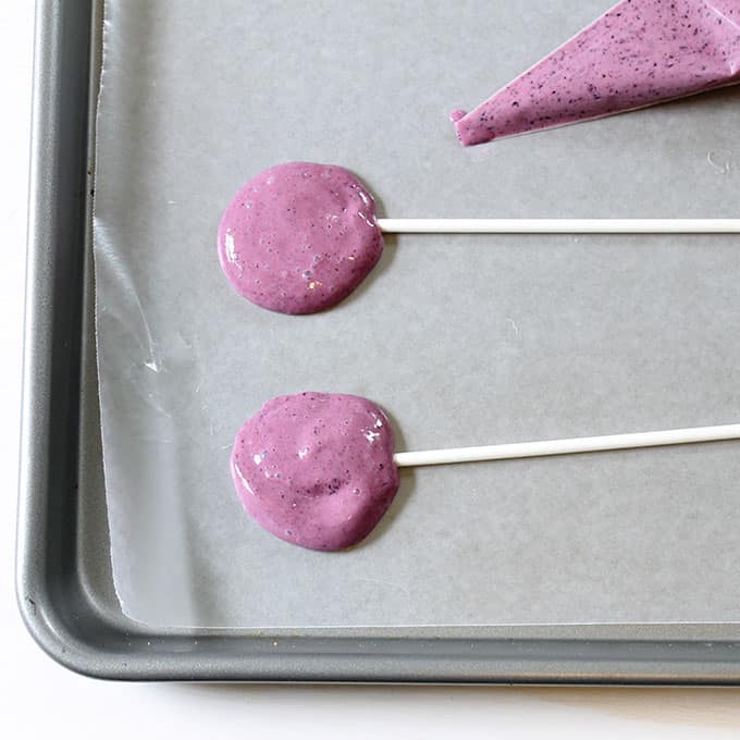 making frozen yogurt pops with blueberries and strawberries 