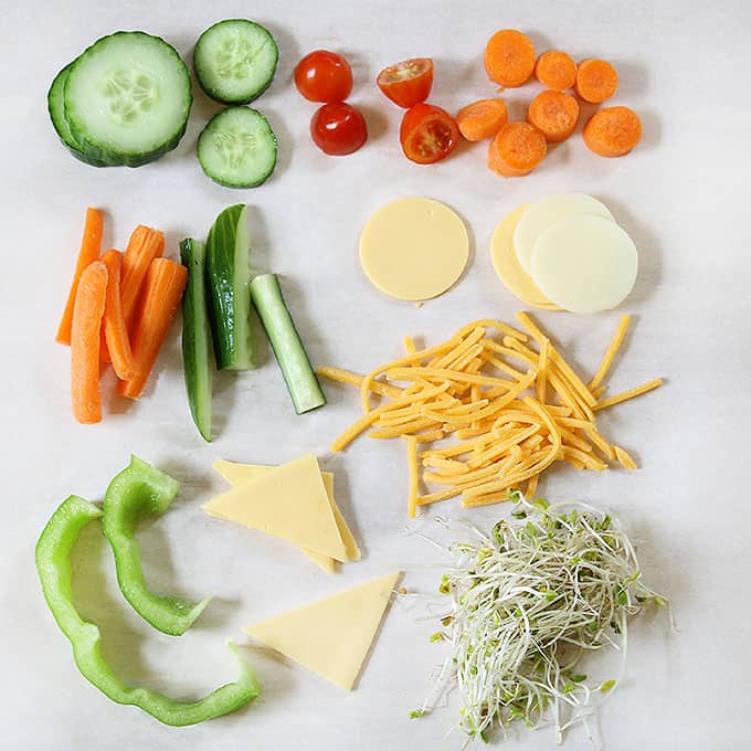 cut up vegetables and cheese for silly veggie faces 