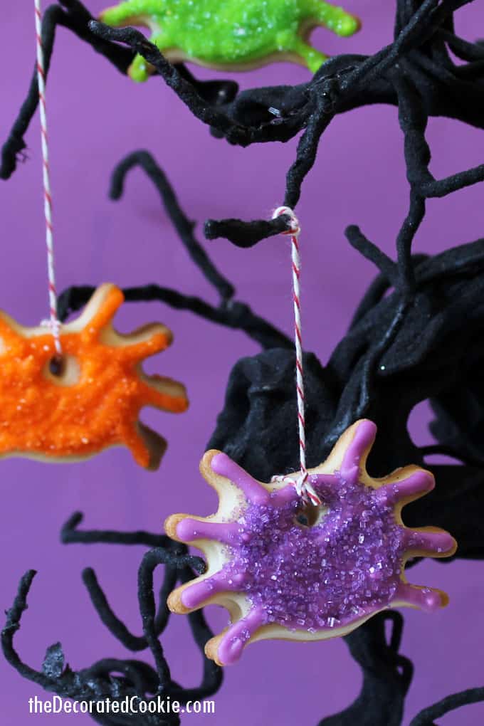 These dangling, sparkling spider ornament cookies double as a spooky Halloween treat AND as Halloween decor. #halloween #halloweenparty #cookies #decoratedcookies #spider #spidercookies #halloweendecor 