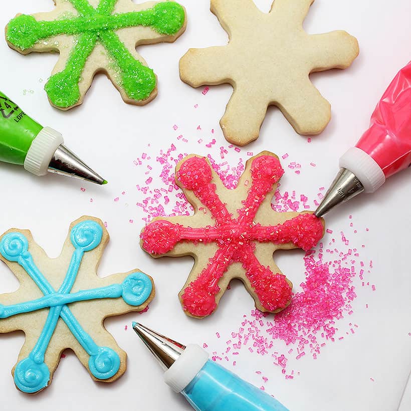 decorating colorful snowflake cookies 