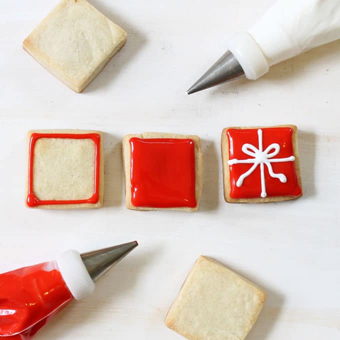 Step-by-step cookie decorating instructions to make bite-size Christmas present cookies. A simple, cute holiday cookie to give or serve at a holiday party