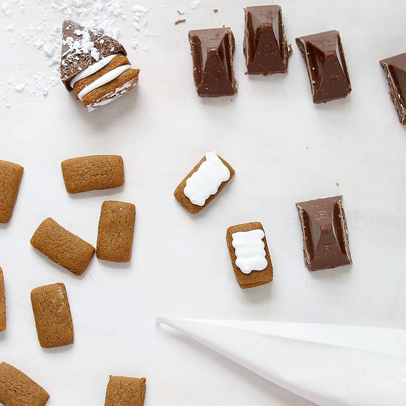 assembling bite-sized gingerbread houses 