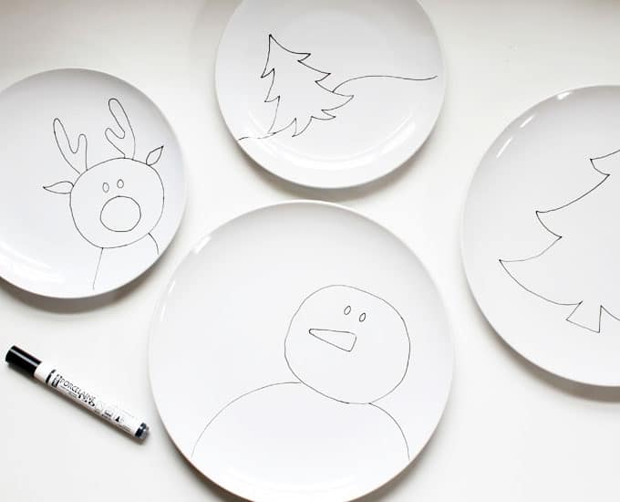 Draw Christmas and winter scenes on plates for kids to create food art. DIY Christmas plates from inexpensive plain white dishes and a China Paint Pen. 