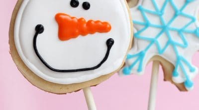snowman and snowflake decorated cookies on sticks