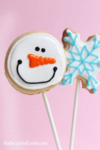 snowman and snowflake decorated cookies on sticks