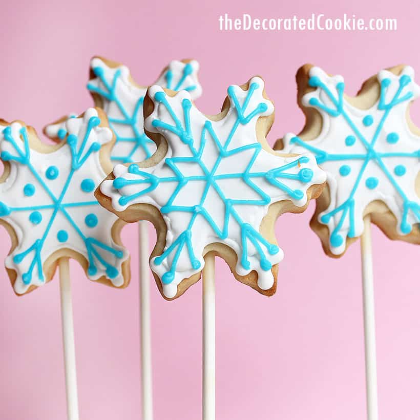 snowman and snowflake decorated cookies on sticks 
