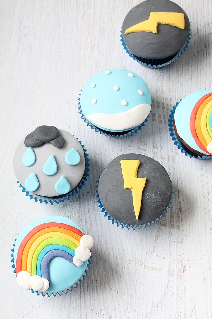 WEATHER CUPCAKES -- How to decorate cupcakes with fondant to make lightning, a rainbow, sow, and rain. Fun food idea for a weather-themed party.