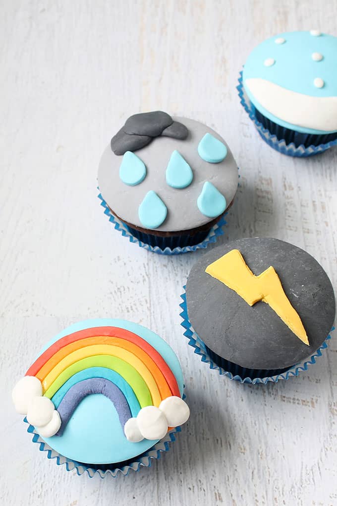 WEATHER CUPCAKES -- How to decorate cupcakes with fondant to make lightning, a rainbow, sow, and rain. Fun food idea for a weather-themed party.