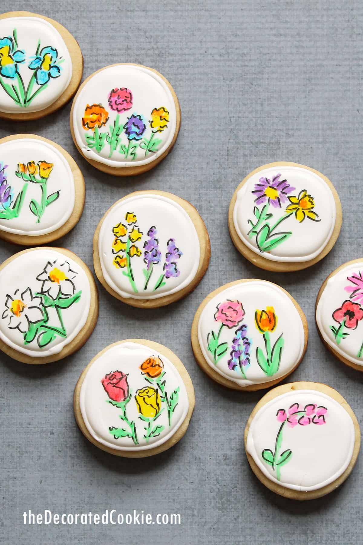 cookies with royal icing and hand-drawn flowers using edible food pens 