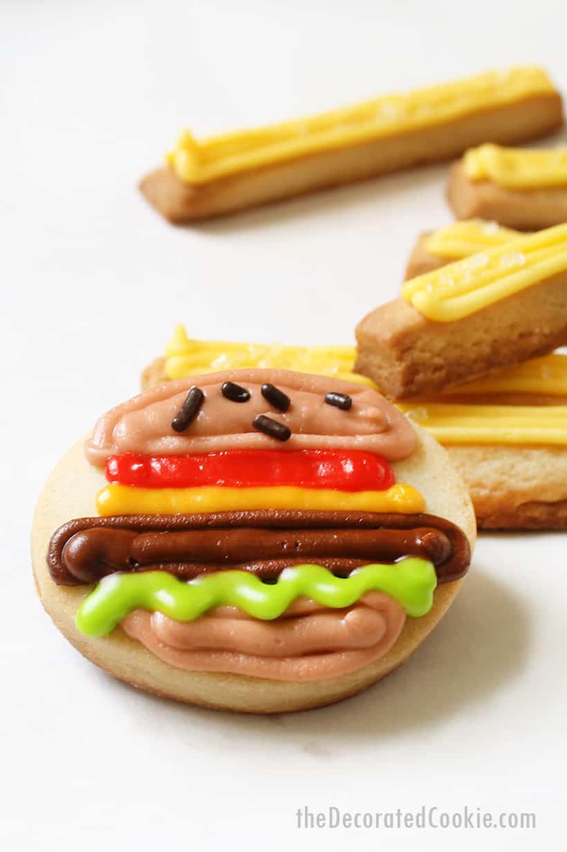 mini decorated cookies with royal icing, burger and fries 