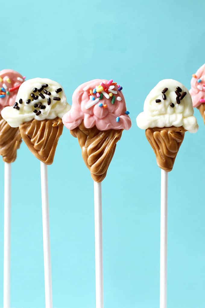 ICE CREAM CONE CANDY POPS -- A fun food idea for summer using store-bought candy melts, sprinkles, and lollip sticks. Ice cream party idea.