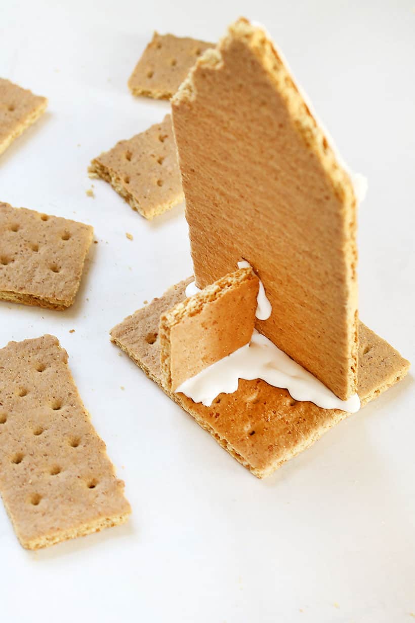 assembling graham cracker gingerbread house