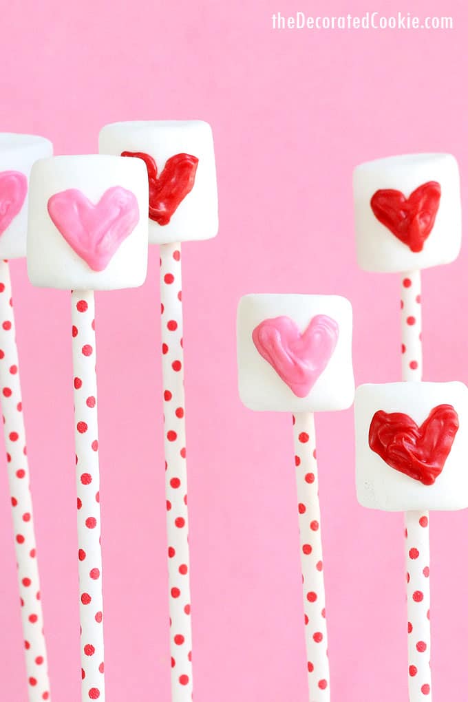 CANDY HEART MARSHMALLOW POPS for Valentine's Day, an easy treat. Pipe hearts on marshmallows with pink and red candy melts.