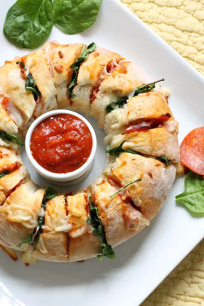 PARTY PIZZA RING -- Delicious, cheese, easy appetizer idea. Bread baked in a ring and stuffed with tomato sauce, pepperoni, spinach and mozzarella. 