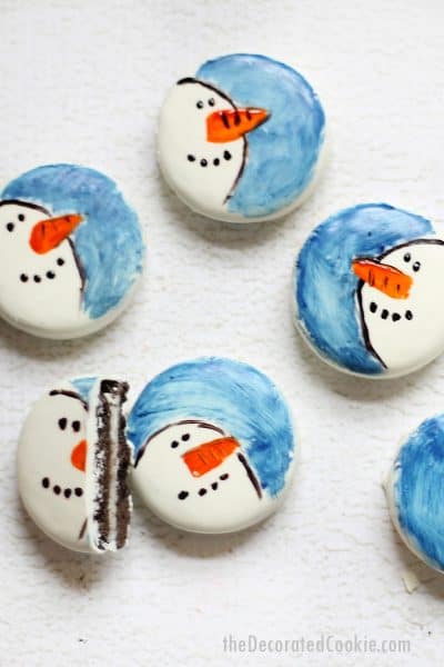 white fudge covered Oreos painted with snowmen for Christmas cookies