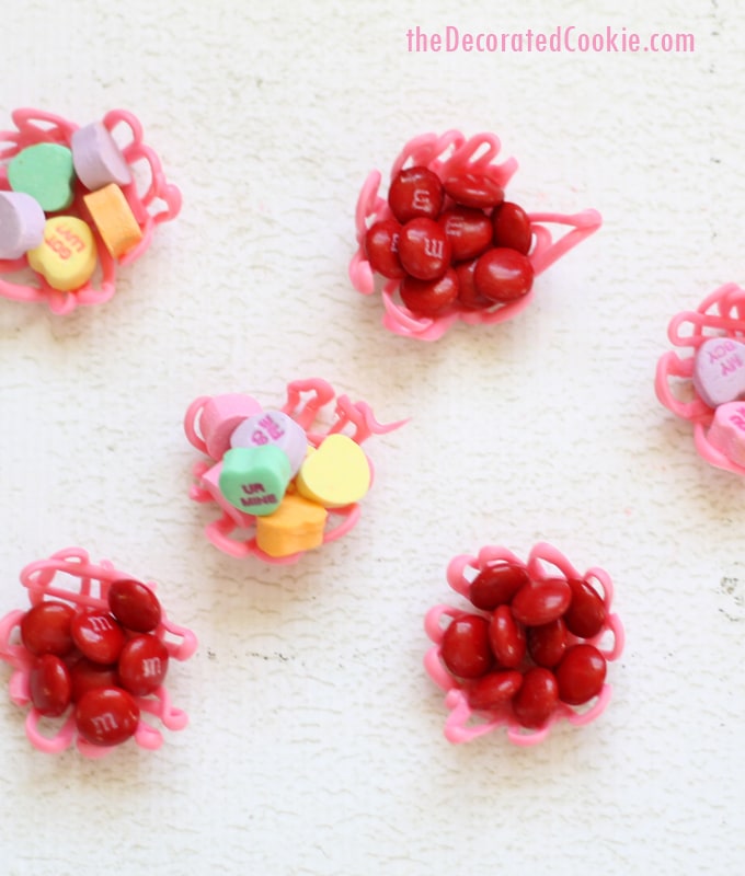 Valentine's Day candy cups by the decorated cookie 