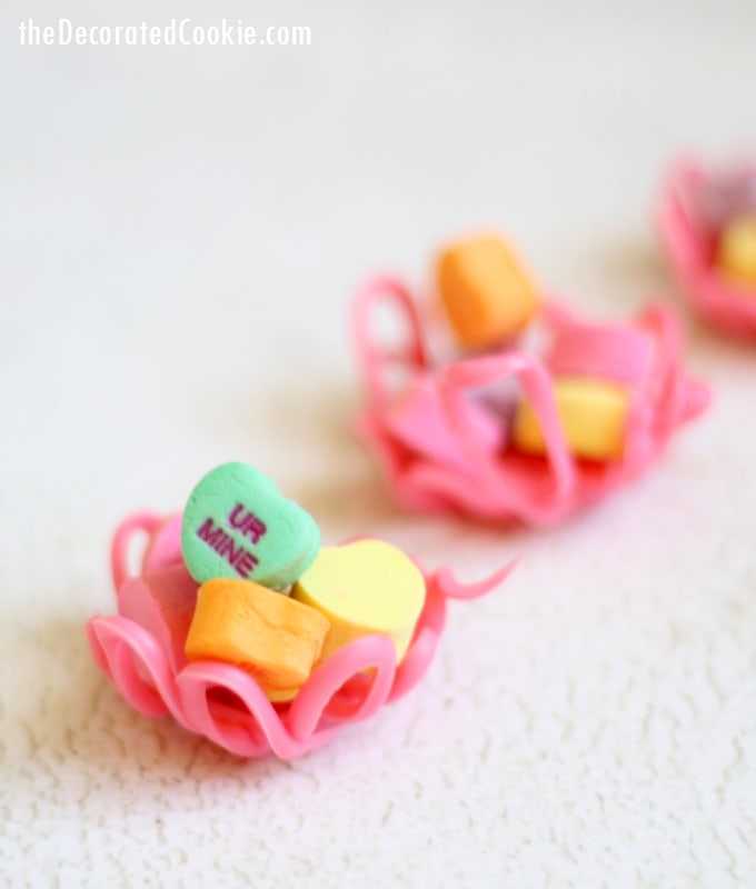 Valentine's Day candy cups by the decorated cookie 