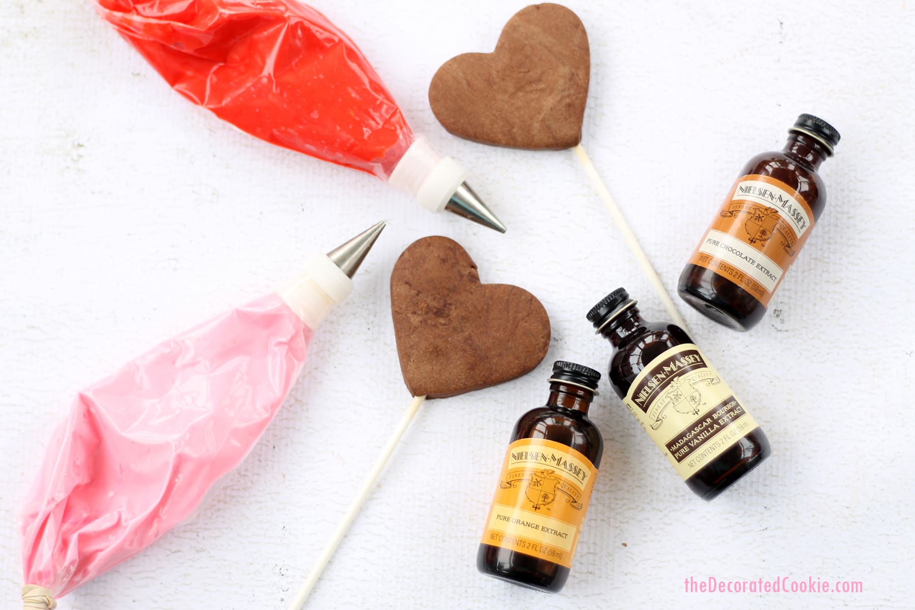 chocolate heart cookie pops with orange buttercream frosting 