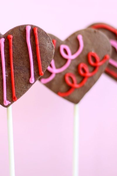 chocolate heart cookie pops with orange buttercream frosting