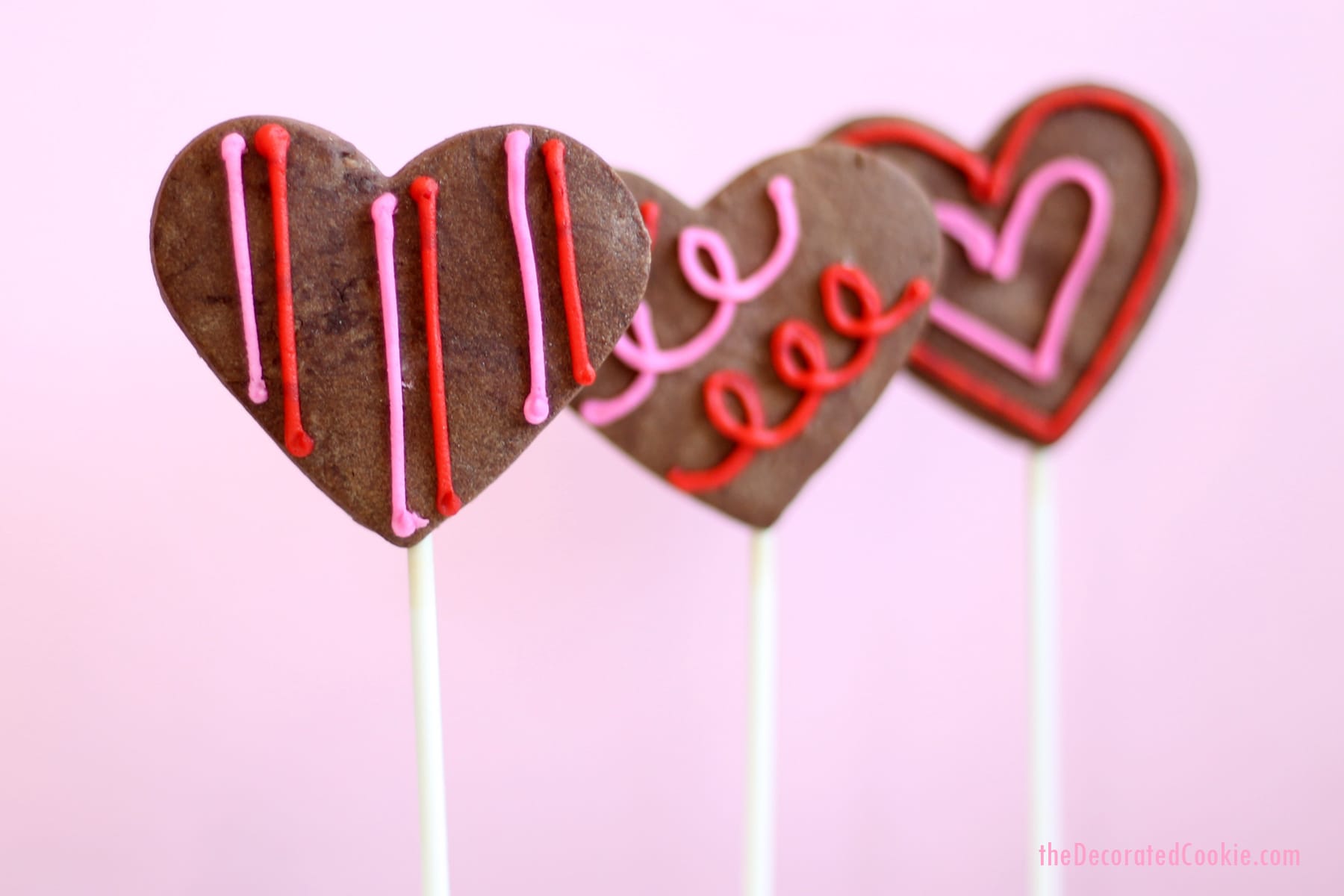 chocolate heart cookie pops with orange buttercream frosting 