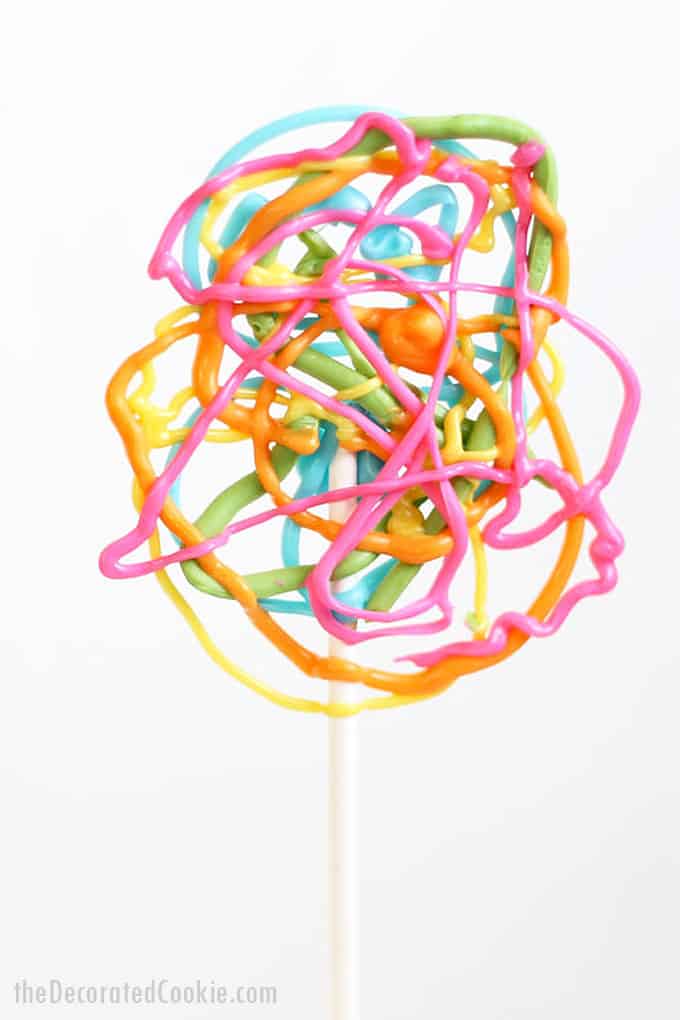 RAINBOW LOLLIPOPS -- Easy, crazy, colorful lollipops made with candy melts or white chocolate. Fun, kid-friendly food idea for a rainbow party.