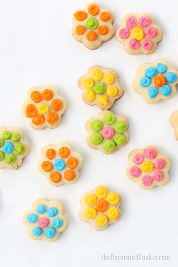 Easy daisy cookie bites, a cute dessert for spring or Mother's Day. Cut-out cookies with royal icing. Video tutorial for decorating cookies included.