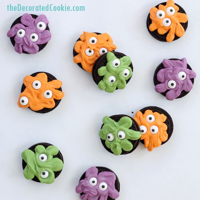 silly monsters made by piping orange, green, and purple candy melts on OREO Cookies.