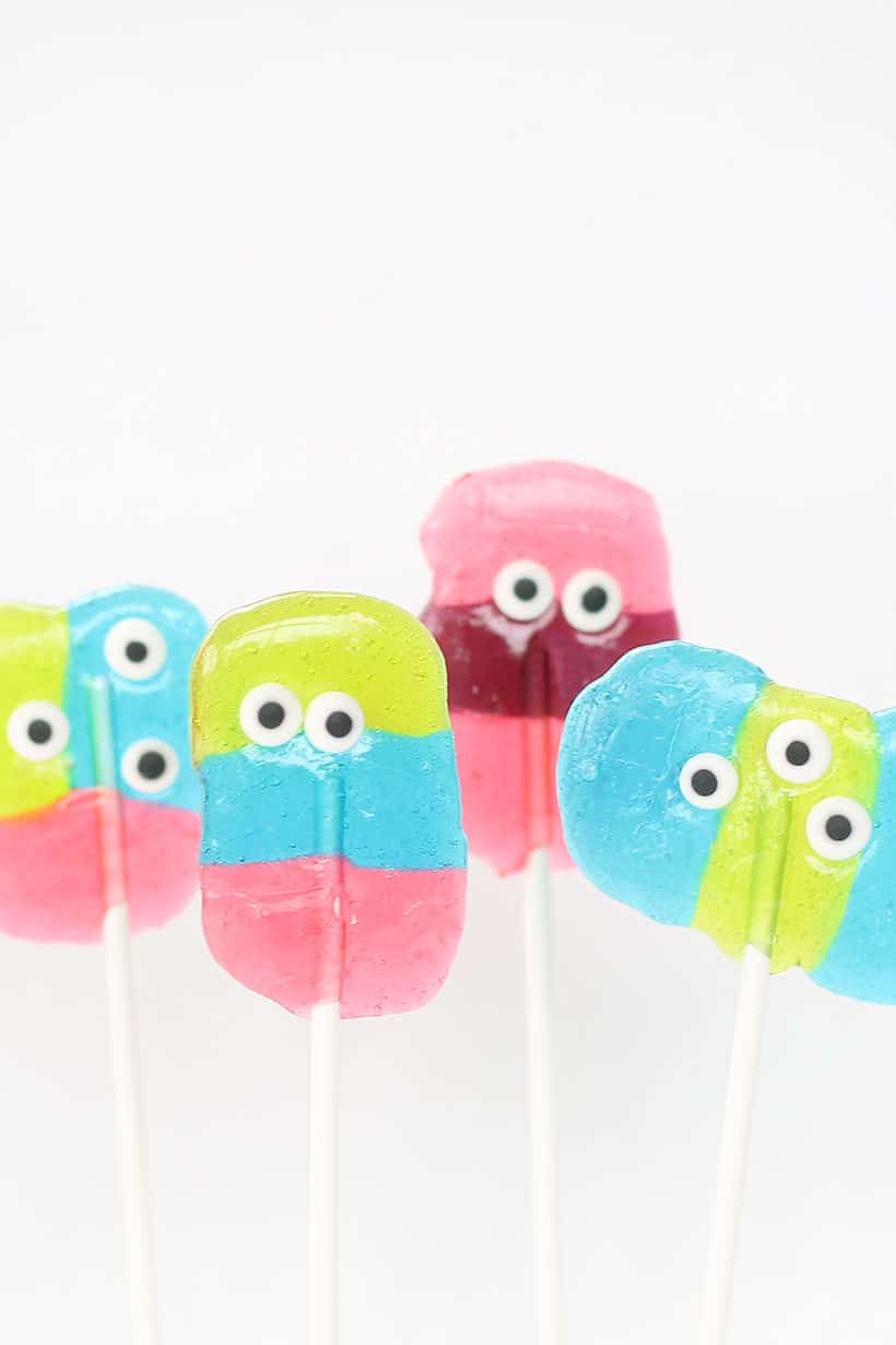 Monster Jolly Rancher lollipop, a kid-friendly Halloween party food or monster party treat. Easy to make using hard candy and candy eyes.