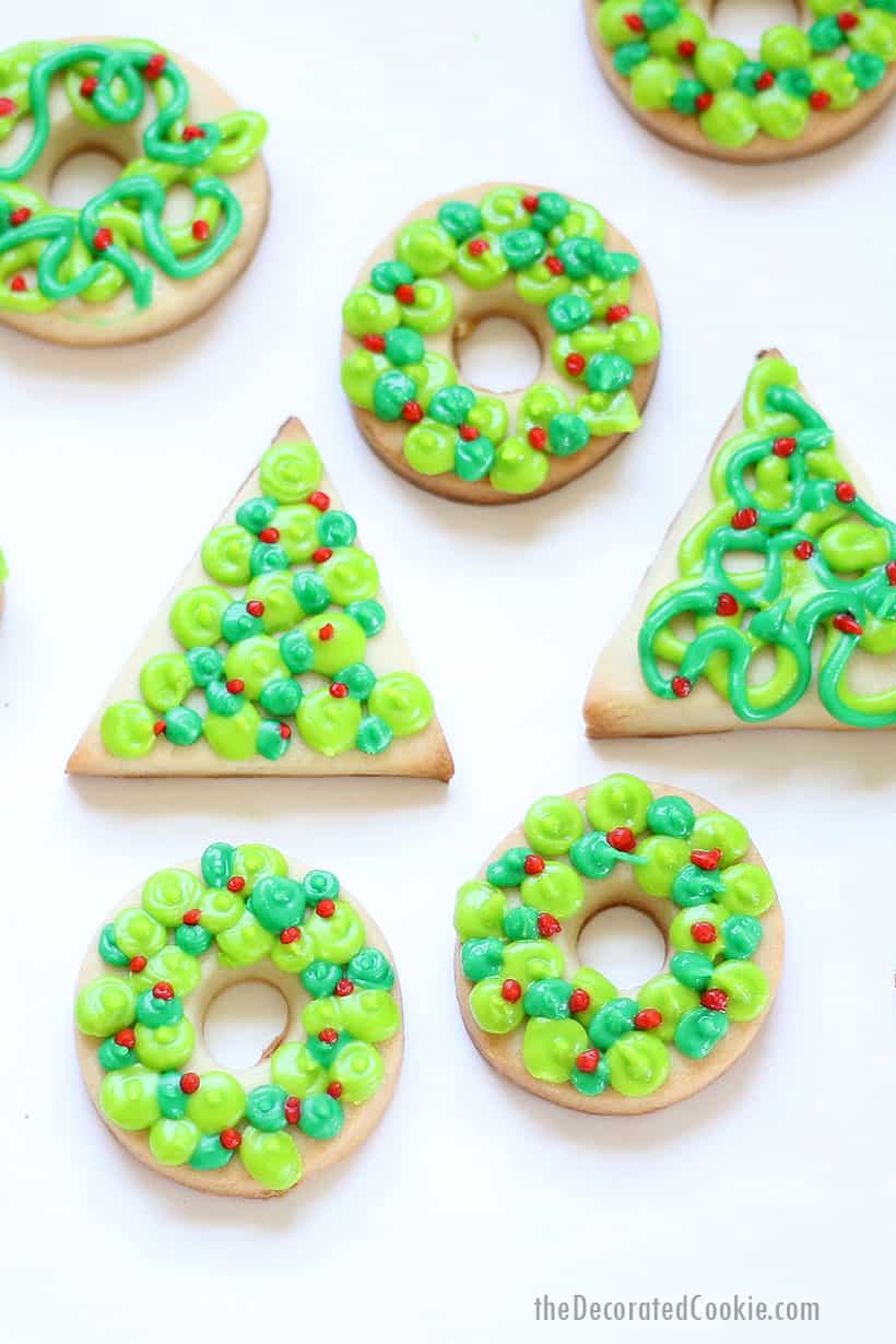 Christmas cookies decorated as trees and wreaths with royal icing