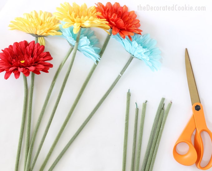 preparing a booze bouquet cutting faux flowers 