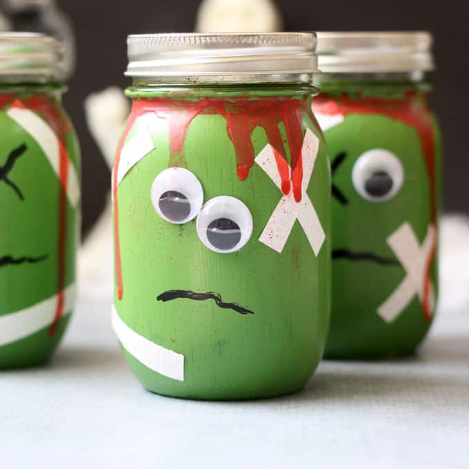 These zombie mason jars (with FREE brains printable!) are a great Halloween decor idea or fun container for packaging Halloween treats.  #masonjarcrafts #halloween #halloweencrafts #monster #zombie #freeprintable